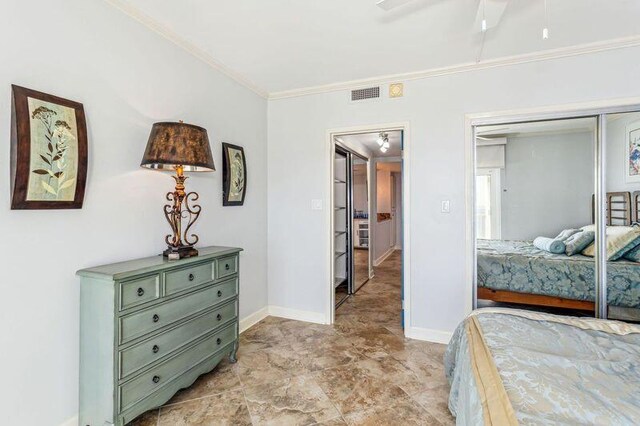 bedroom with ornamental molding and a closet
