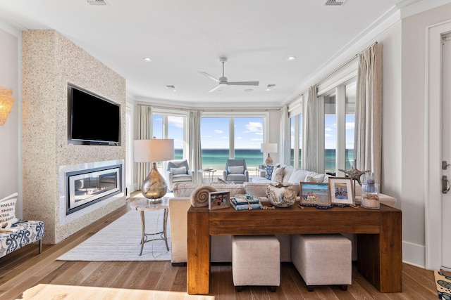 living room with crown molding, hardwood / wood-style flooring, and ceiling fan