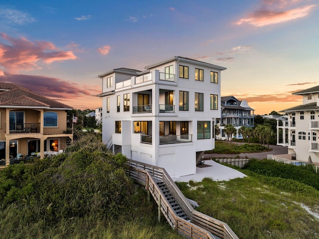 view of back house at dusk