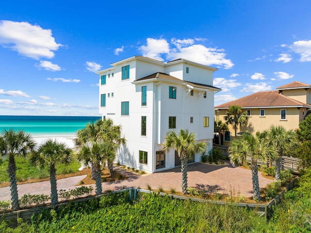 rear view of house featuring a water view