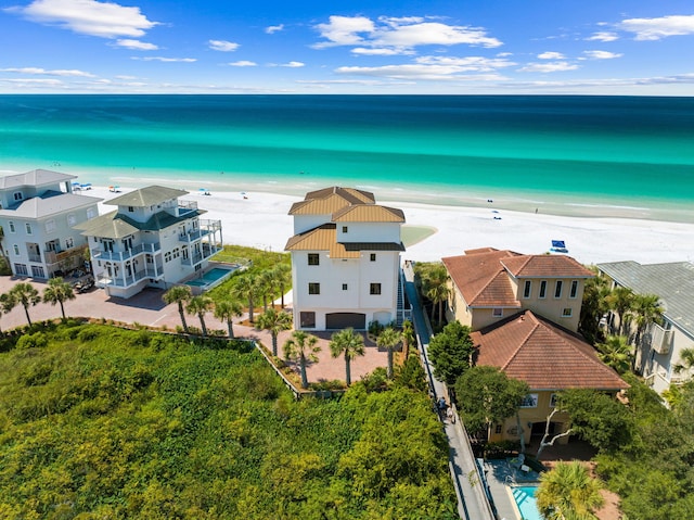 bird's eye view featuring a water view and a beach view