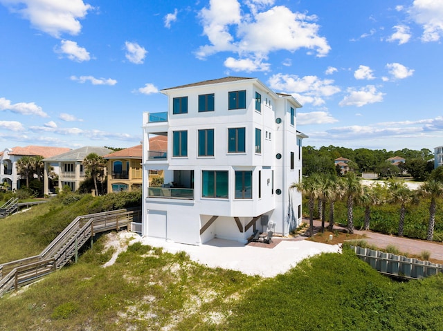 back of property featuring a balcony