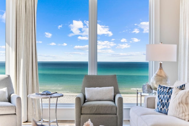 living room featuring a view of the beach and a water view