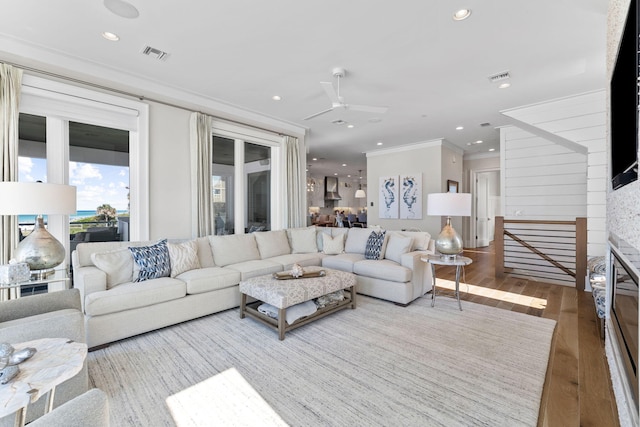 living room featuring hardwood / wood-style floors and ornamental molding