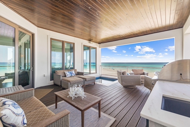 wooden deck featuring a water view and outdoor lounge area