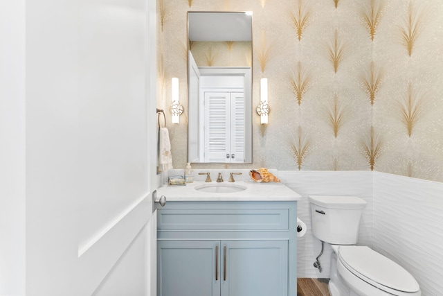 bathroom featuring vanity and toilet