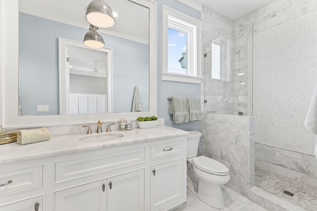 bathroom with vanity, tiled shower, crown molding, and toilet