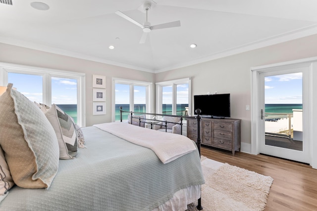 bedroom with multiple windows, access to exterior, and light wood-type flooring