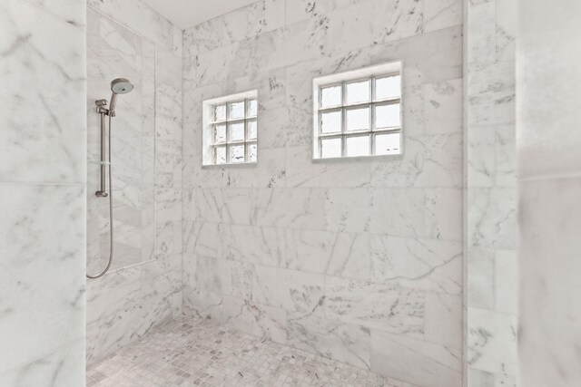 bathroom with a tile shower