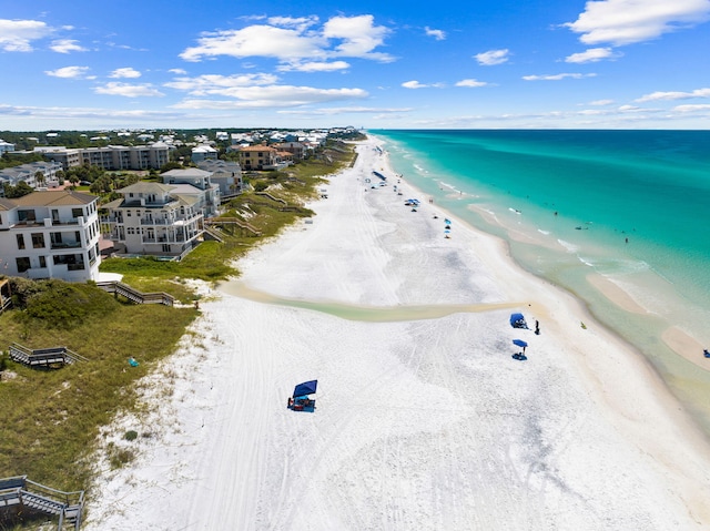 birds eye view of property featuring a water view and a beach view