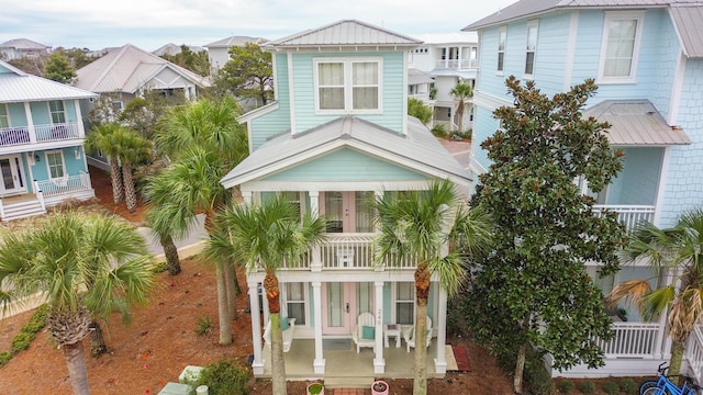 raised beach house featuring a balcony