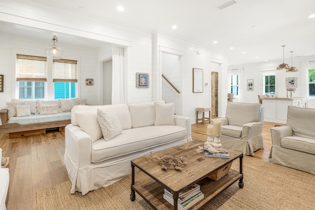 36 E Ruskin St, Santa Rosa Beach, FL 32459 - living room with ornamental molding, a wealth of natural light, and light wood-type flooring