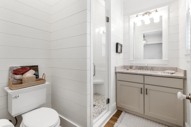 36 E Ruskin St, Santa Rosa Beach, FL 32459 - bathroom with vanity, wood-type flooring, a shower with door, and toilet