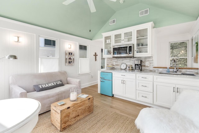 36 E Ruskin St, Santa Rosa Beach, FL 32459 - living room with ceiling fan, high vaulted ceiling, light hardwood / wood-style floors, and sink