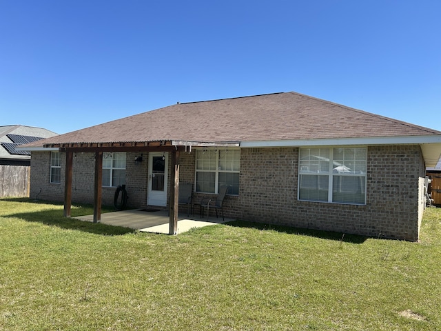 rear view of property with a patio, a yard, brick siding, and a pergola