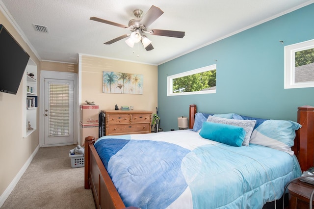 carpeted bedroom with crown molding, ceiling fan, and a textured ceiling