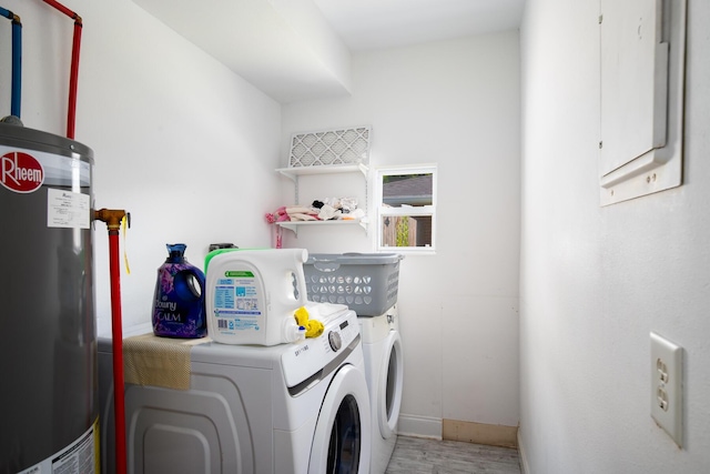 laundry area with washer and dryer, hardwood / wood-style floors, and water heater