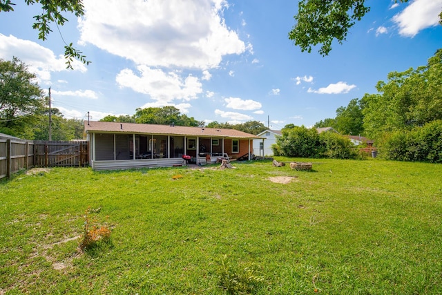 rear view of house with a patio and a yard