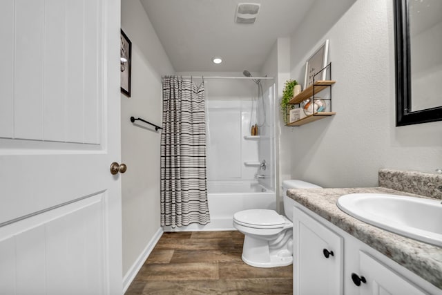 full bath featuring visible vents, toilet, shower / bath combo with shower curtain, vanity, and wood finished floors