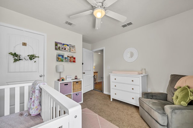 carpeted bedroom featuring visible vents and a ceiling fan