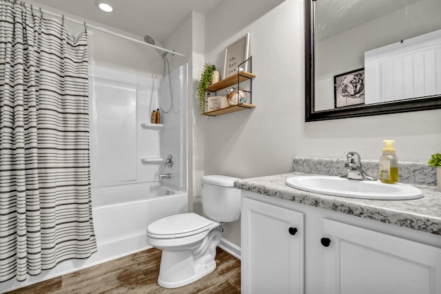 bathroom featuring shower / bath combo, vanity, toilet, and wood finished floors