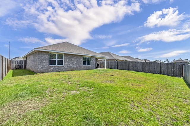 back of property with a yard and a fenced backyard