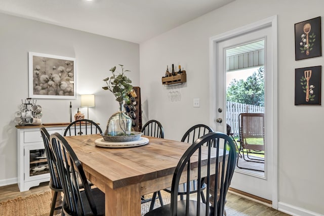 dining space with light wood-style floors and baseboards