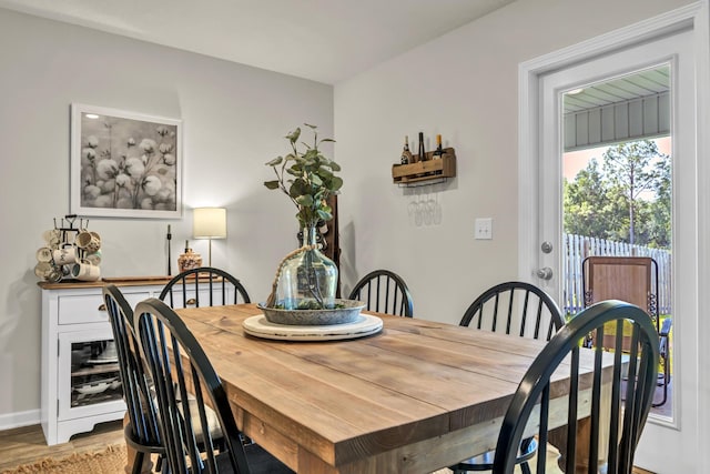 dining room featuring light wood-type flooring and baseboards