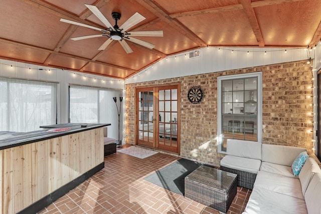 sunroom with vaulted ceiling, ceiling fan, french doors, and visible vents