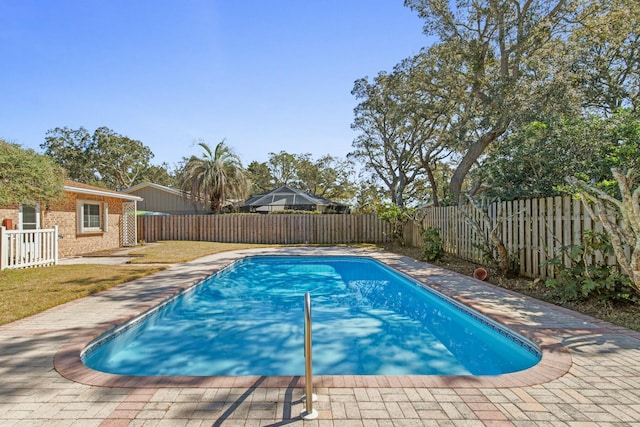 view of swimming pool with a patio, a lawn, a fenced backyard, and a fenced in pool