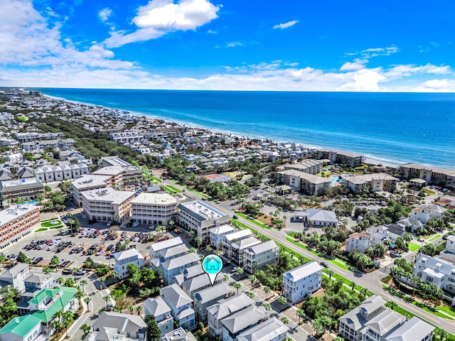 drone / aerial view featuring a water view and a view of the beach