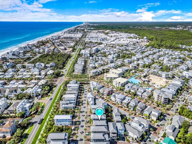 drone / aerial view featuring a water view and a view of the beach