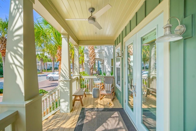 sunroom with wood ceiling and a ceiling fan