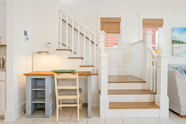 stairs featuring tile patterned flooring