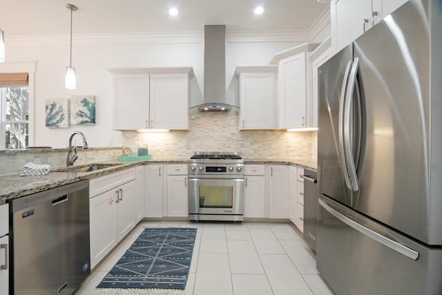 kitchen featuring tasteful backsplash, wall chimney exhaust hood, appliances with stainless steel finishes, crown molding, and a sink