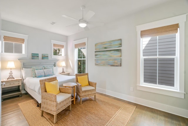 bedroom featuring light wood-style floors, ceiling fan, and baseboards