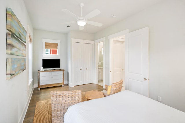 bedroom with baseboards, visible vents, ceiling fan, wood finished floors, and a closet