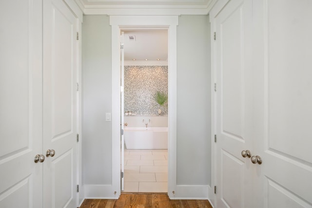 hall featuring baseboards and wood finished floors