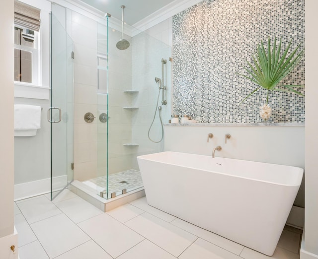 full bath with a soaking tub, tile patterned flooring, crown molding, a shower stall, and tile walls