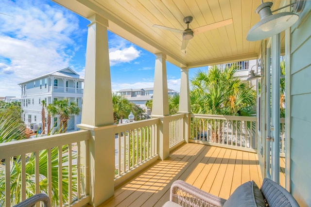 wooden terrace featuring a ceiling fan