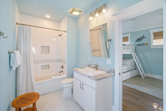 full bathroom with shower / bath combo, vanity, and toilet