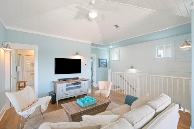 living room featuring lofted ceiling, wooden ceiling, wood finished floors, and a ceiling fan