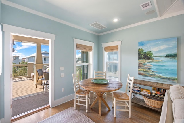 dining space featuring a wealth of natural light, visible vents, and wood finished floors