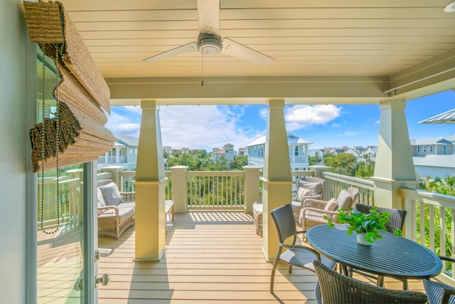 wooden terrace featuring a residential view and ceiling fan