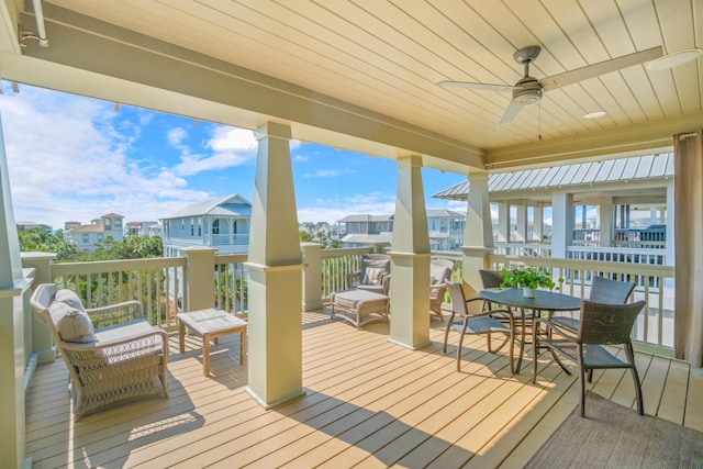 wooden terrace with a ceiling fan and a residential view