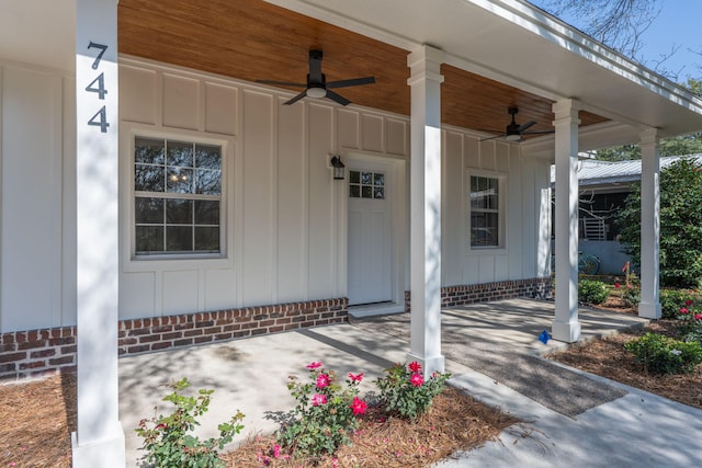 doorway to property with ceiling fan and a porch