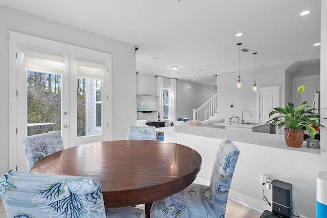 dining area featuring french doors, recessed lighting, visible vents, light wood-style floors, and stairs