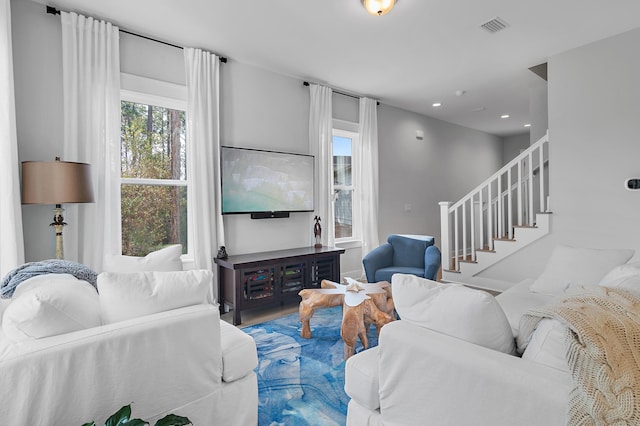 living room with stairs, visible vents, and recessed lighting