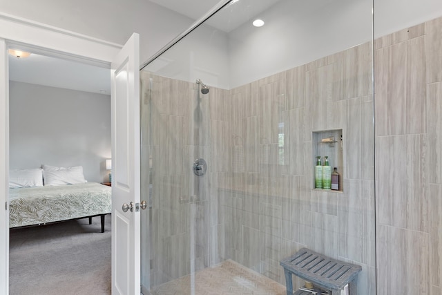 full bathroom featuring a tile shower and ensuite bathroom