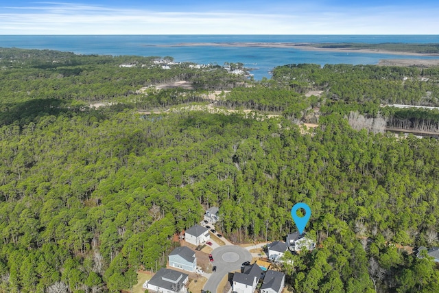 aerial view with a water view and a forest view